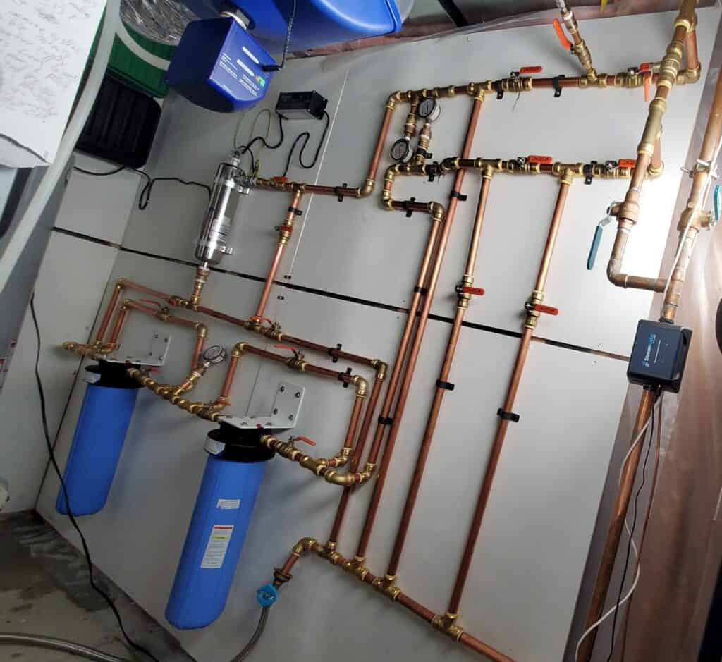Water filtration system with copper piping and filters for clean drinking water.