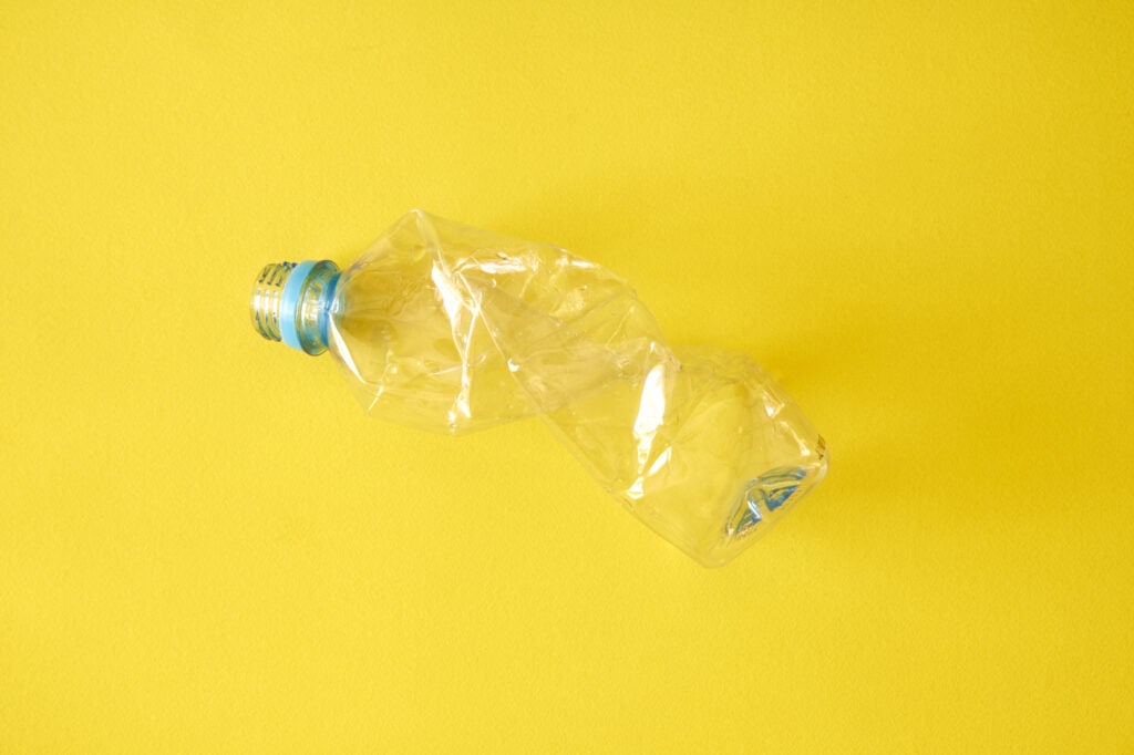 Image of a twisted, empty single-use plastic bottled water container