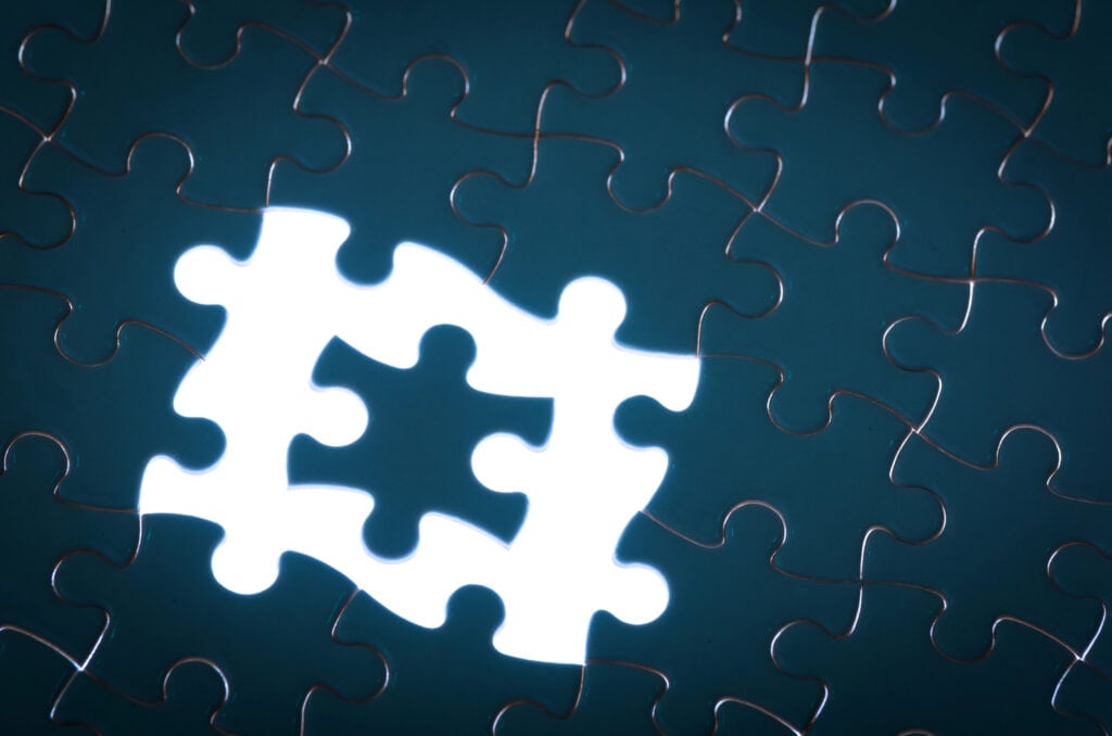 Brightly lit missing puzzle piece on dark blue puzzle background, symbolizing water awareness.