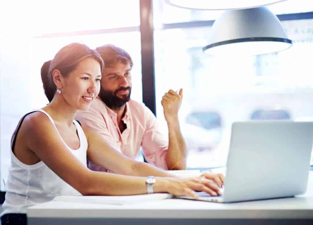 Couple at home reviewing simple water guidance together on a laptop.